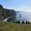 A group of visitors sitting and enjoying the scenery at the Cliffs of Moher