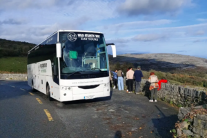 Wild Atlantic Way Day Tours coach parked overlooking the Burren landscape